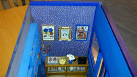 paintings on the wall and display case with rare decks